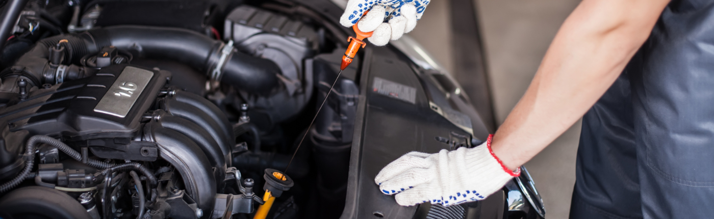 Mechanic changing the engine oil on a vehicle - Car Servicing Southmead